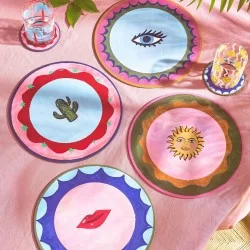 Pink table view of Eleanor Bowmer Electric Coast Icon round placemats with glasses