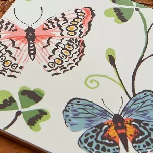 Butterfly Grove Coaster close up with flowers