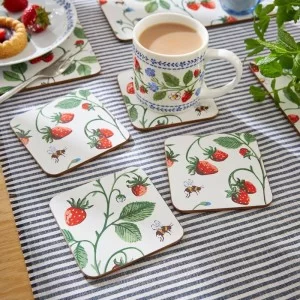 Dining table with Strawberry Patch Coasters and mug of tea