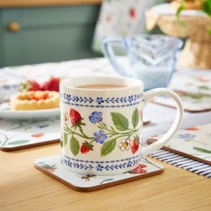 Dining table with Strawberry Patch Coaster with cup of tea